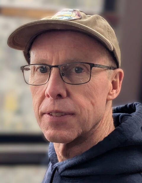 Jerry Scripps in blue hoodie and tan baseball hat, he is wearing glasses